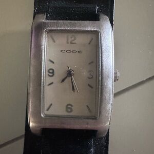 Code unisex silver watch with black strap.